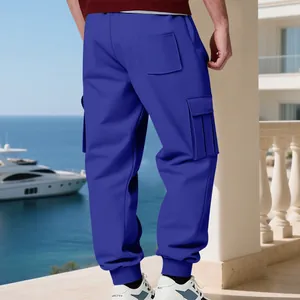Men's blue heavy fleece cargo sweatpants shown from the back on a luxury balcony