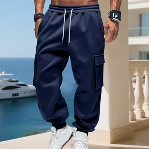 Detailed close-up of navy blue men's cargo pants with drawstring waist and flap pockets
