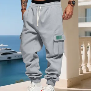 Close-up detail of stylish grey heavy fleece cargo sweatpants with multi-pocket design