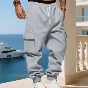 Close-up detail of grey fleece cargo sweatpants with multi-pockets and drawstring waist