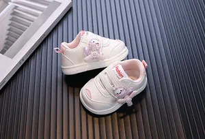 Detail of baby sneakers with a rotating cartoon propeller character on a ribbed background