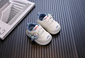 Detail view of white cartoon baby walking shoes with blue accents and propeller decor