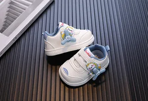 White toddler walking shoes featuring a rotating cartoon airplane design for baby boys and girls