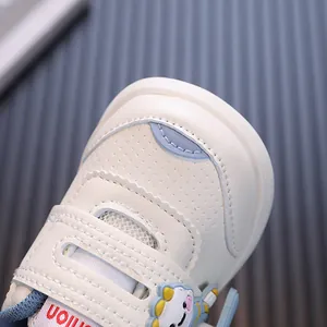 Comfortable white toddler walking shoes with blue accents and cute cartoon character