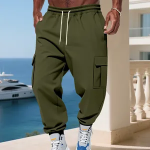 Men's olive green fleece cargo pants with drawstring and multi-pockets in outdoor setting.