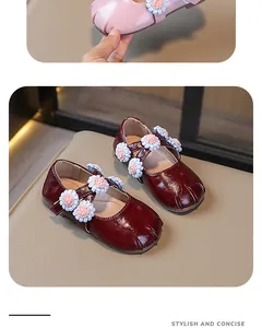Elegant detail view of girls' Mary Jane shoes with cute flower accents and soft soles.