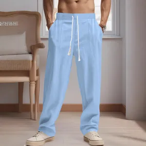 Men's light blue breathable linen pants with a white drawstring in a loose fit