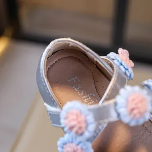 Elegant silver girls Mary Jane dress shoes featuring soft soles and cute flower details