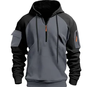 Close-up of men's gray half-zip hoodie featuring functional arm pockets and hood