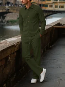Detail view of men's dark green corduroy long-sleeve shirt and trousers casual set