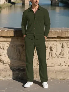 Full body shot of a man wearing a dark olive green corduroy button-down shirt and pants set