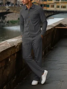 Full body view of men's dark grey corduroy shirt and trousers set in outdoor setting.