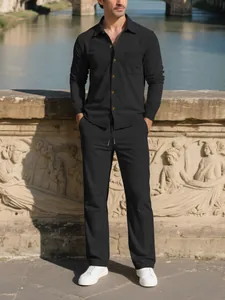Full view of men's black corduroy casual set showing texture and fit in an outdoor setting.