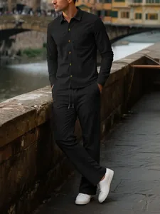 Detailed view of men's black corduroy long sleeve shirt and trousers leisure set