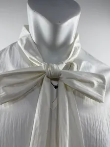 Detail of white men's shirt featuring a stylish large bow-tie collar design