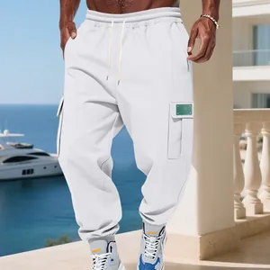 Detailed shot of men's white heavyweight fleece cargo sweatpants in a luxury outdoor setting