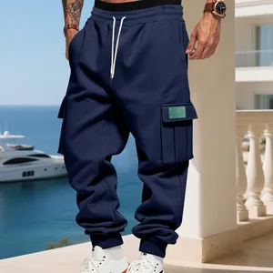 Detail of navy blue cargo sweatpants on model featuring drawstring and side pockets