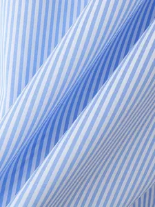 Macro close-up showing the fine texture and blue white stripes of this men's shirt fabric.