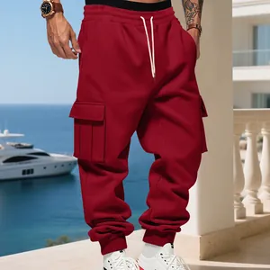 Red heavyweight fleece men's cargo sweatpants shown in a luxury outdoor setting