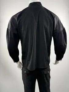 Back view of a men's loose black long-sleeved shirt with dropped shoulders