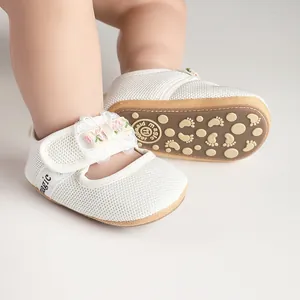 Close-up of white mesh baby princess shoes with lace flower and anti-slip rubber sole.