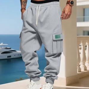 Detailed view of grey cargo sweatpants with ribbed cuffs and side utility pocket