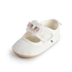 High-quality detail view of white mesh baby girl princess shoes with floral bow embroidery