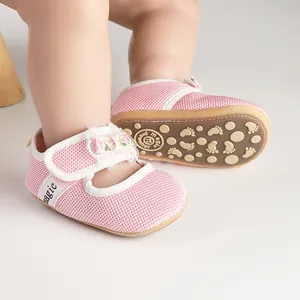 Close-up of pink mesh baby shoes with non-slip footprint soles and velcro straps.
