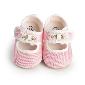 Detailed top view of pink mesh baby girl princess shoes with floral lace bow