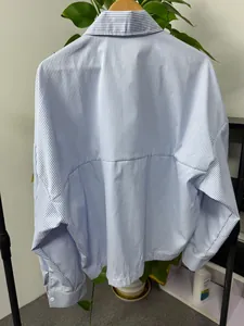 Close-up rear view showing the back yoke and vertical stripes of this blue men's shirt