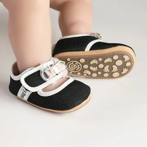Close-up of black mesh baby princess shoes with floral bow and non-slip sole