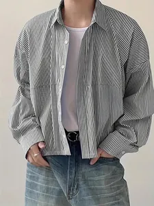 Detailed view of a men's loose vertical striped long-sleeve shirt with a classic lapel
