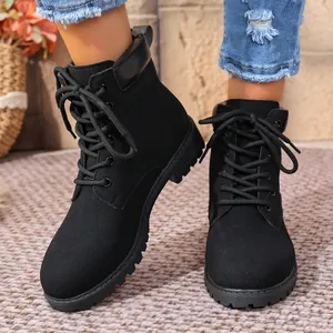 Rugged black lace-up ankle boots for women featuring a lug sole and matte suede finish