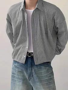 Detail view of men's loose vertical striped long-sleeved shirt with a lapel collar design