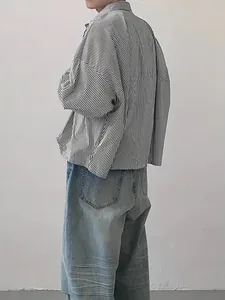 Side view of an oversized vertical striped long-sleeve shirt with a relaxed fit