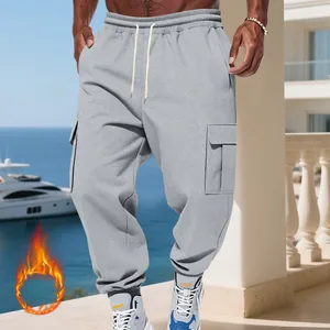 Detailed view of men's loose grey fleece cargo pants with multi-pocket design