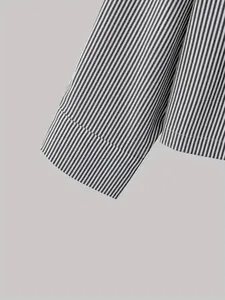 Detailed macro shot of sleeve cuff on a grey and white vertical striped cotton shirt