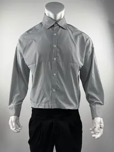 Detailed front view of a vertical black and white striped long-sleeved shirt on a mannequin