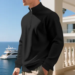 Men's casual black half-zip fleece sweatshirt shown in a stylish outdoor setting.