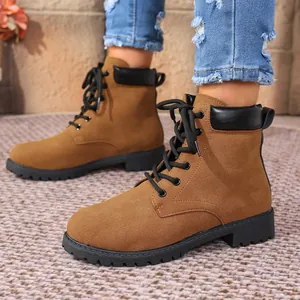 Detailed macro view of women's brown suede lace-up Martin boots with black collar