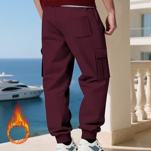 Back view of men's heavyweight fleece-lined cargo pants in burgundy with multi-pockets.
