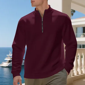 Burgundy men's half-zip casual fleece pullover sweatshirt in a coastal balcony setting.