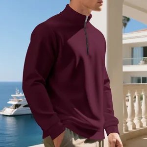 Close-up of men's burgundy half-zip fleece sweatshirt with ribbed cuffs and stand collar