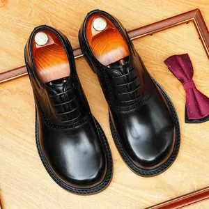Men's black leather brogue Derby shoes with round toe for business or wedding events.
