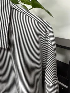 Detailed macro shot of vertical striped men's shirt showing fabric texture and seams