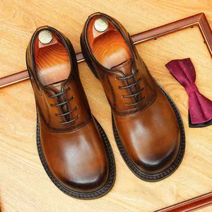 Elegant brown burnished leather brogue Derby shoes with round toe and wooden shoe trees.