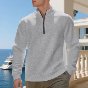 Men's light grey half-zip fleece sweatshirt shown in a lifestyle coastal outdoor setting