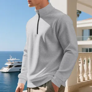 Close-up detail of a men's casual grey half-zip fleece pullover sweatshirt on model