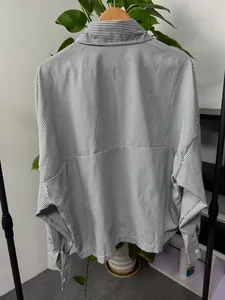 Macro detail view of the back of a men's vertical striped long-sleeve loose shirt