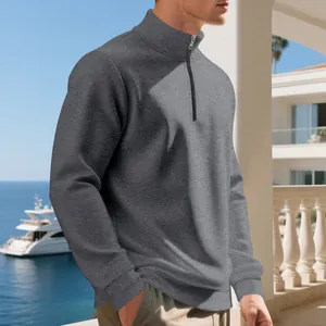 Close-up of a men's grey fleece half-zip casual sweatshirt worn in a lifestyle setting